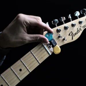 ROMBO Guitar Pick Holder - placing it on an electric guitar headstock ROMBO Guitar Pick Holder